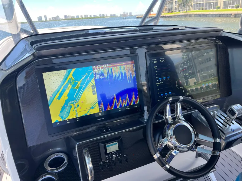 Slide: The Image of Dashboard of 2023 Nor-Tech 340 Sport Open Center Console with navigation screens. - 3