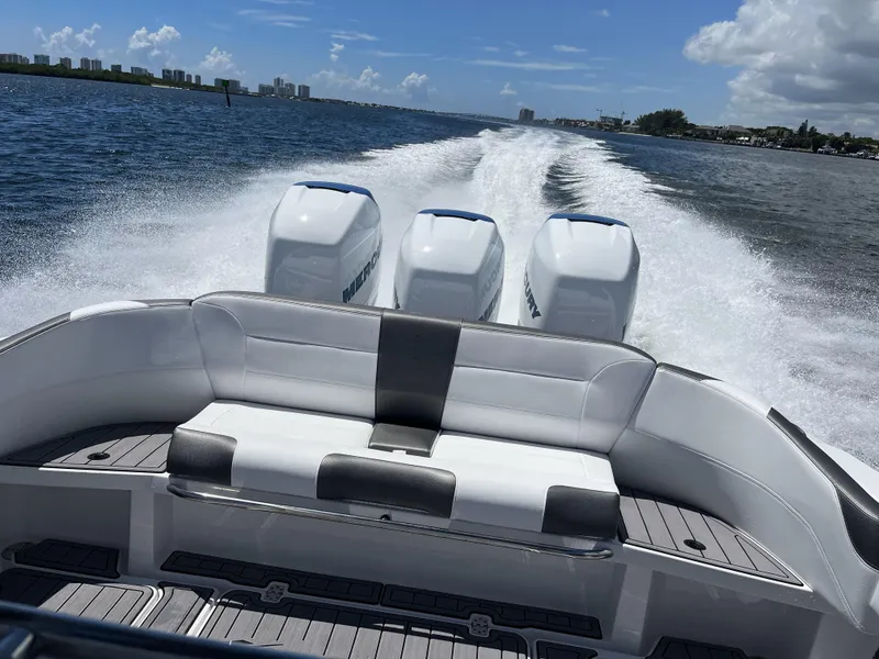 Slide: The Image of 2023 Nor-Tech 340 Sport Open Center Console speeding on water, triple Mercury engines. - 5