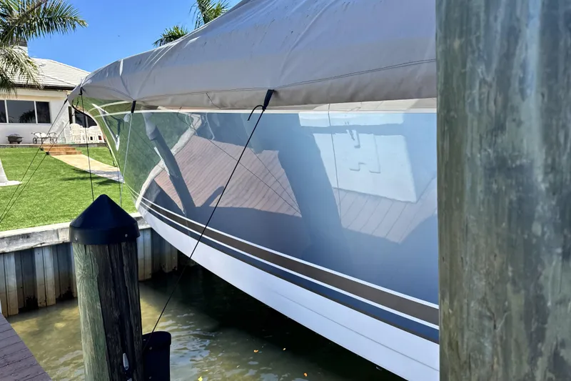 Slide: The Image of 2023 Nor-Tech 340 Sport Open Center Console boat docked under cover. - 8