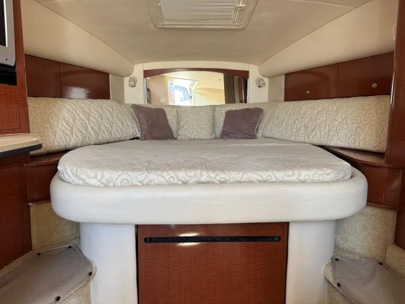 Slide: The Image of Interior cabin of 2005 Sea Ray 320 Sundancer with plush bedding and wood accents. - 13