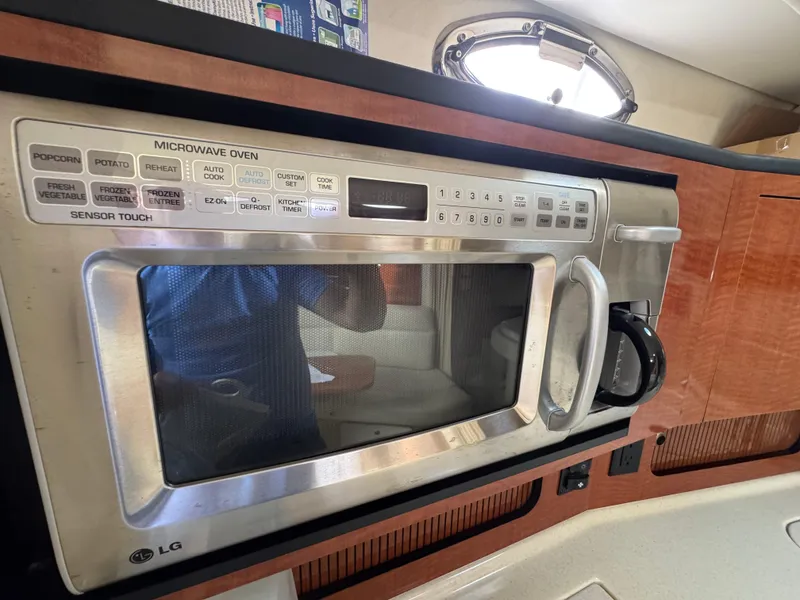 Slide: The Image of Microwave oven inside 2005 Sea Ray 320 Sundancer yacht kitchen, featuring sensor touch controls. - 16