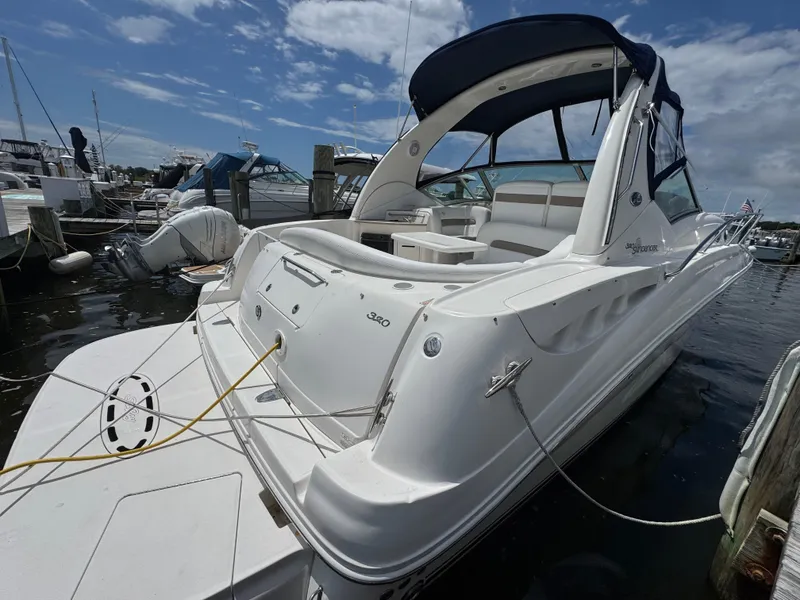 Slide: The Image of 2005 Sea Ray 320 Sundancer docked at marina under blue sky. - 2