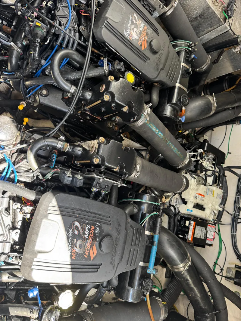 Slide: The Image of Engine compartment of a 2005 Sea Ray 320 Sundancer boat, showcasing mechanical components. - 20