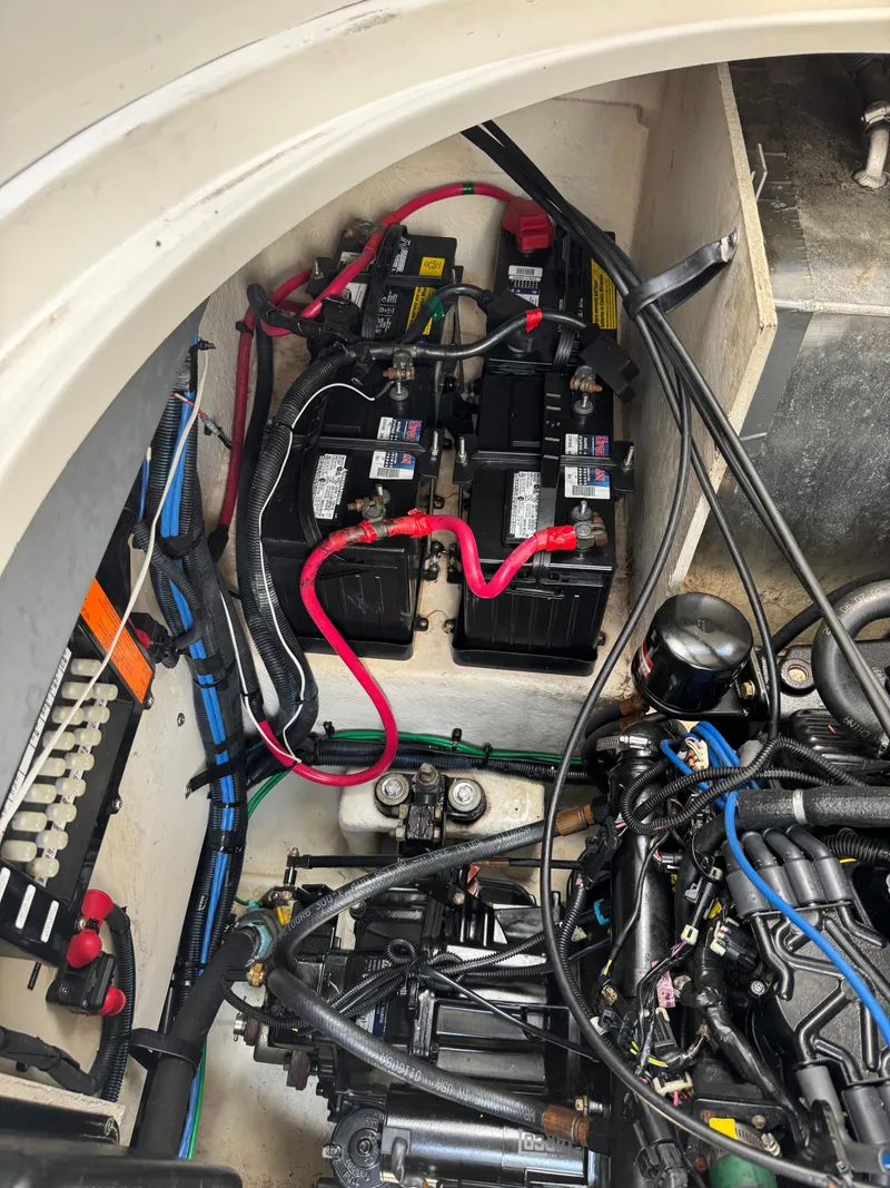 Slide: The Image of Engine compartment of a 2005 Sea Ray 320 Sundancer with visible batteries and wiring. - 21