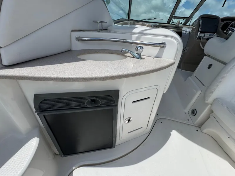 Slide: The Image of 2005 Sea Ray 320 Sundancer cockpit with sink and storage area. - 9