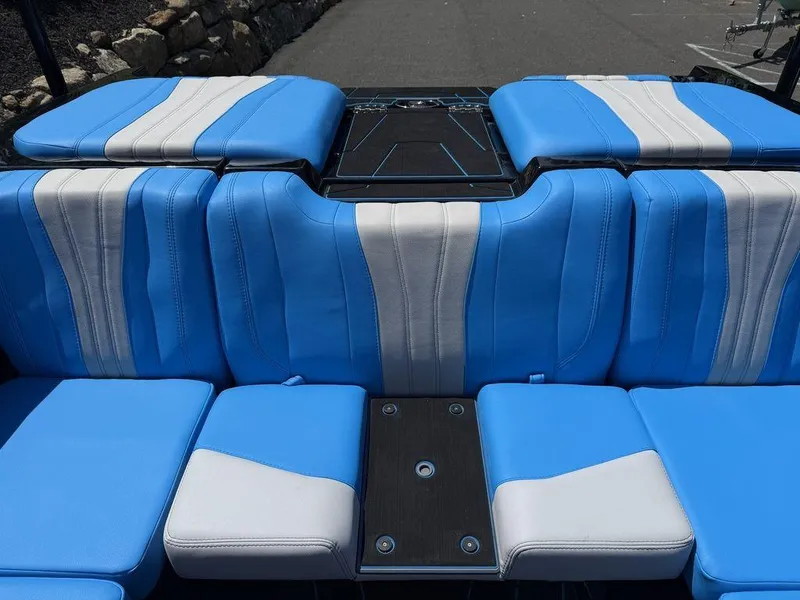Slide: The Image of 2026 Malibu 22 LSV boat interior with blue and white seating. - 15