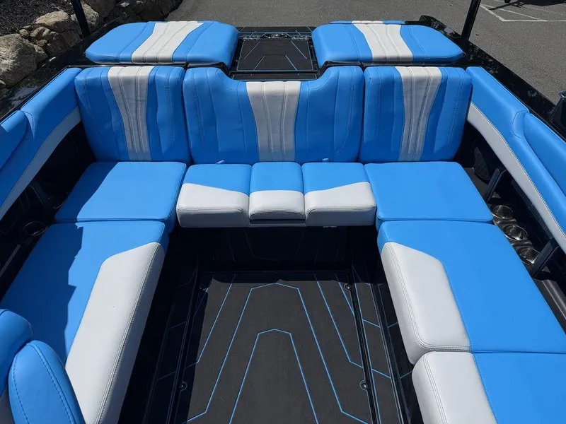 Slide: The Image of 2026 Malibu 22 LSV boat interior with blue and white seating arrangement. - 6