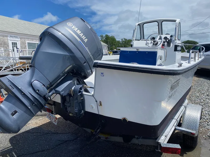 Slide: The Image of 1999 Maritime Skiff 20D with Yamaha outboard motor on trailer, parked outdoors. - 3