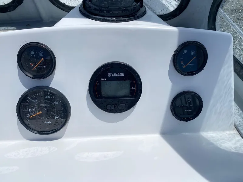 Slide: The Image of Dashboard of a 1999 Maritime Skiff 20D with Yamaha and Suzuki gauges. - 6