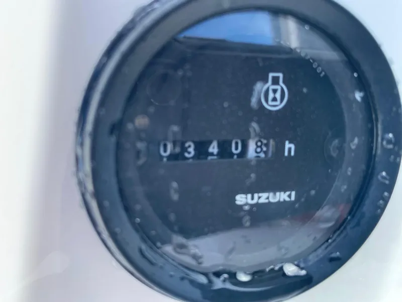 Slide: The Image of Close-up of a Suzuki hour meter reading 3408 hours on a Maritime Skiff 20D, 1999 model. - 8