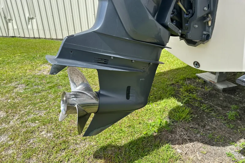 Slide: The Image of Outboard motor of 2004 Grady-White Fisherman 222 on grassy surface. - 11
