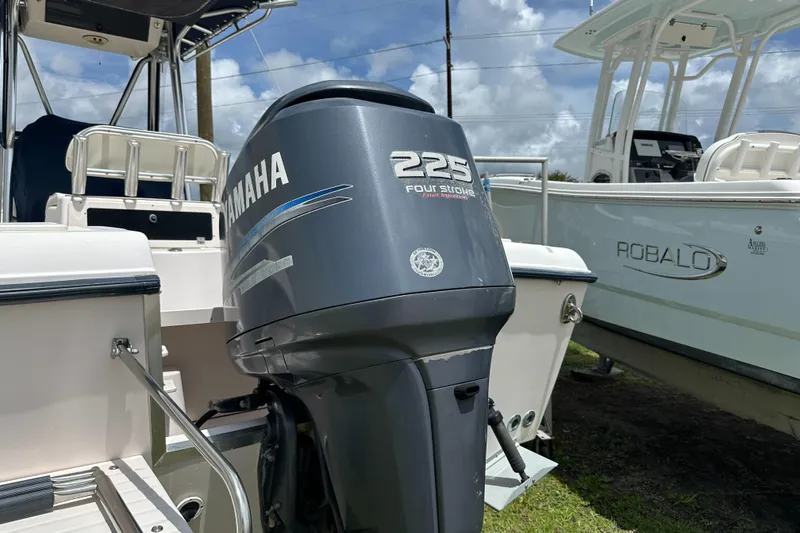 Slide: The Image of 2004 Grady-White Fisherman 222 with Yamaha 225 outboard motor, parked beside a Robalo boat. - 12