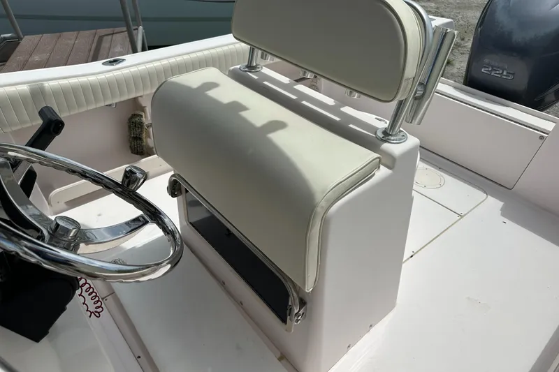 Slide: The Image of 2004 Grady-White Fisherman 222 boat interior with steering wheel and cushioned seating. - 31