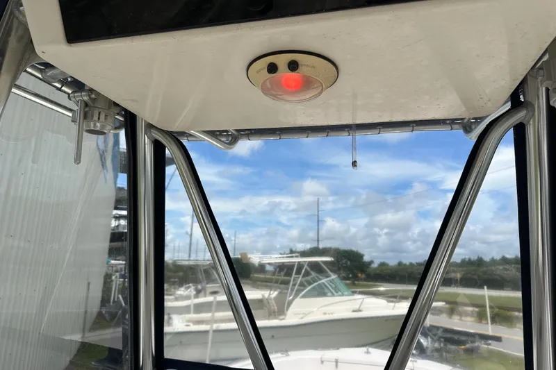 Slide: The Image of 2004 Grady-White Fisherman 222 interior with red light and exterior view. - 45