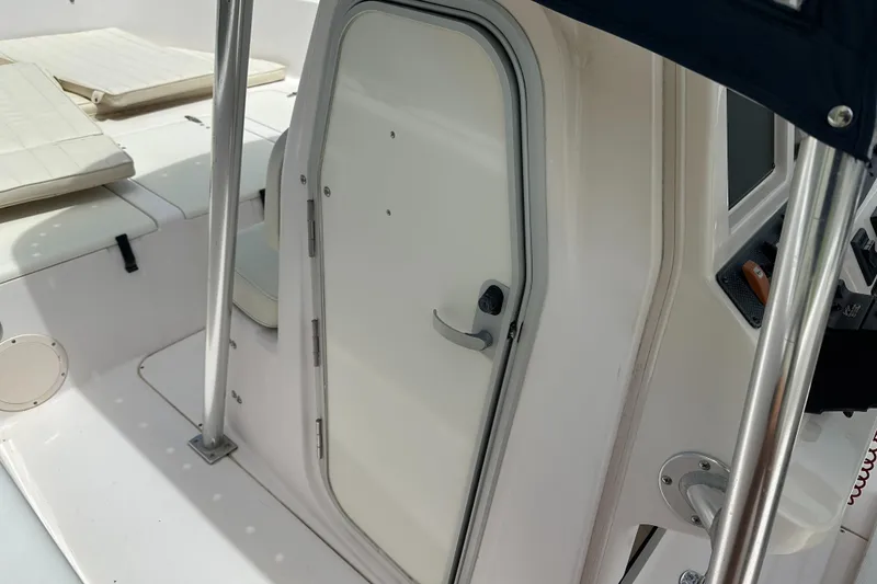 Slide: The Image of 2004 Grady-White Fisherman 222 boat interior with cabin door and seating area. - 46