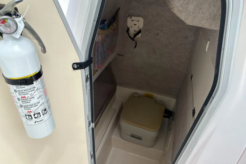 Slide: The Image of 2004 Grady-White Fisherman 222 interior with fire extinguisher and portable toilet. - 47