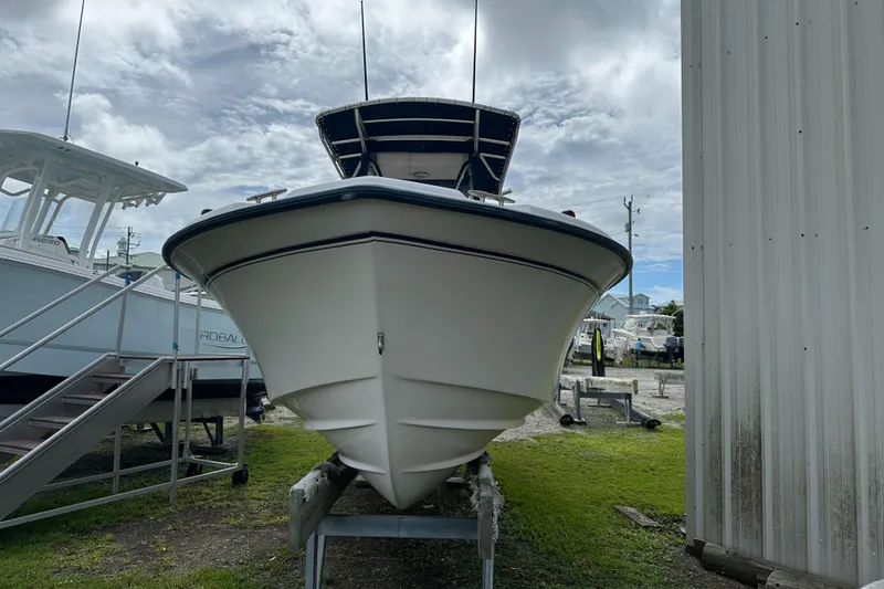 Slide: The Image of 2004 Grady-White Fisherman 222 boat on trailer, parked outdoors under cloudy sky. - 7