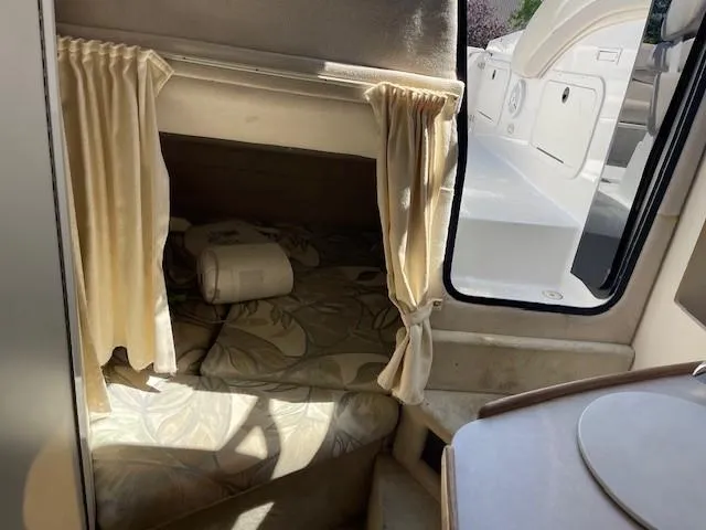 Slide: The Image of Interior cabin of 1999 Four Winns 258 Vista boat with bed and curtains. - 17