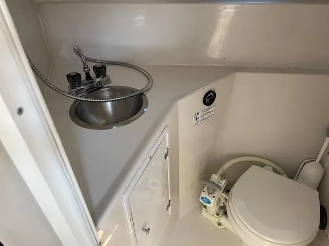Slide: The Image of 1999 Four Winns 258 Vista boat bathroom with sink and toilet. - 19