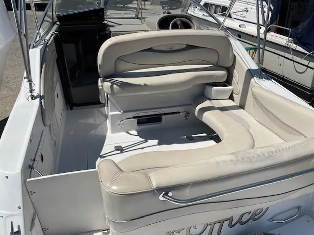 Slide: The Image of 1999 Four Winns 258 Vista boat interior with white seating and steering wheel. - 5