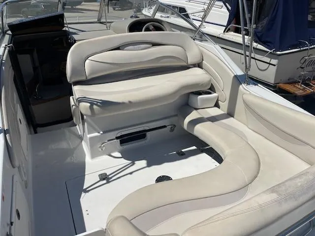Slide: The Image of 1999 Four Winns 258 Vista boat interior with white seating and steering wheel. - 7