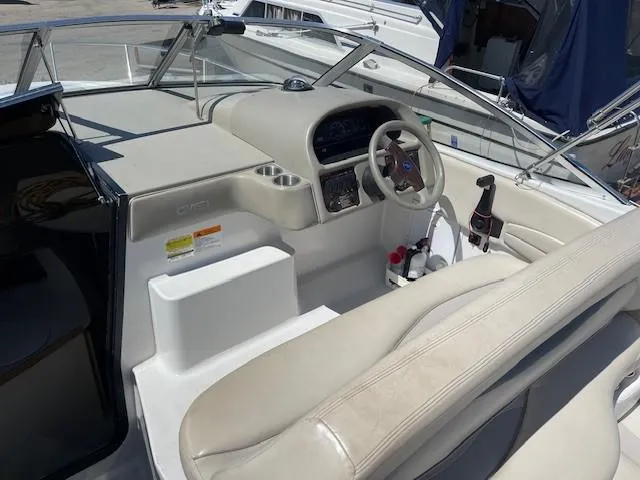Slide: The Image of 1999 Four Winns 258 Vista boat interior with steering wheel and seating area. - 8