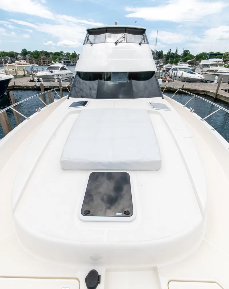 Slide: The Image of 2024 Maritimo M55 yacht docked at marina, showcasing sleek design and spacious deck. - 11