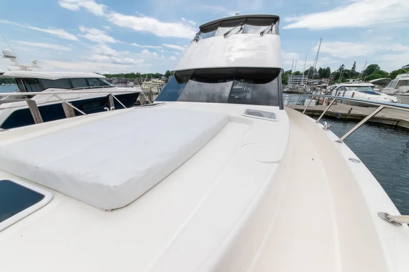 Slide: The Image of 2024 Maritimo M55 yacht docked at marina, showcasing sleek design and spacious deck. - 12