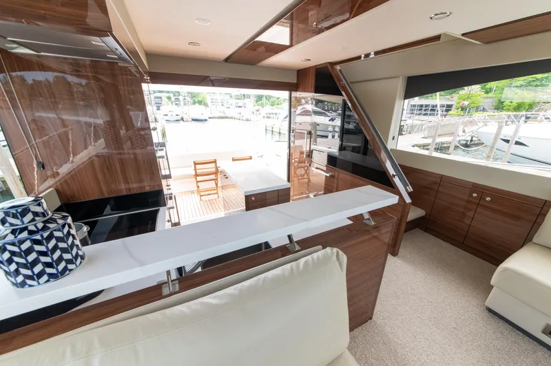 Slide: The Image of Luxurious interior of 2024 Maritimo M55 yacht with elegant wood finishes and marina view. - 17