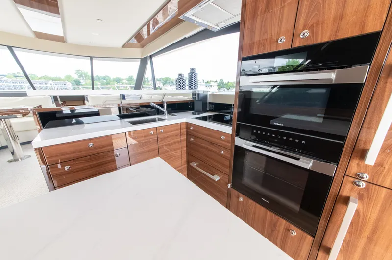 Slide: The Image of Luxurious kitchen interior of 2024 Maritimo M55 yacht with modern appliances and wood cabinetry. - 19