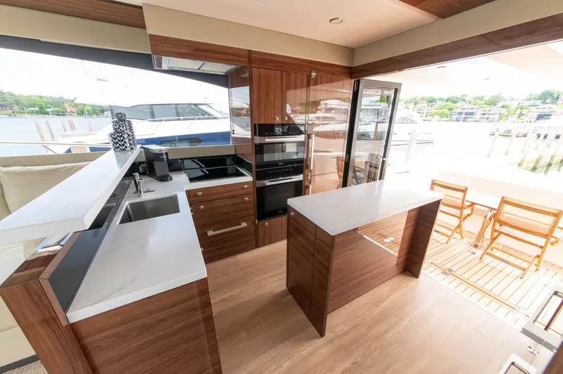 Slide: The Image of Luxurious 2024 Maritimo M55 yacht kitchen with modern appliances and outdoor seating. - 20