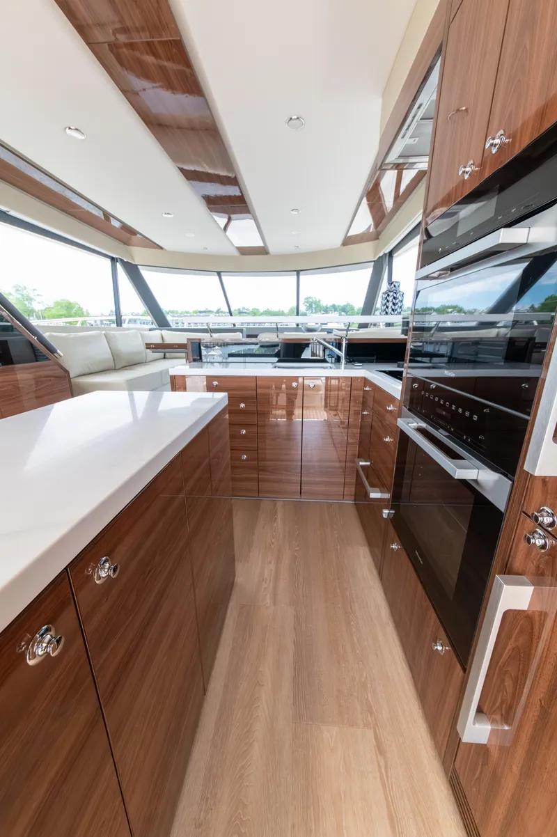 Slide: The Image of Luxurious kitchen interior of 2024 Maritimo M55 yacht with modern wood finishes and appliances. - 21