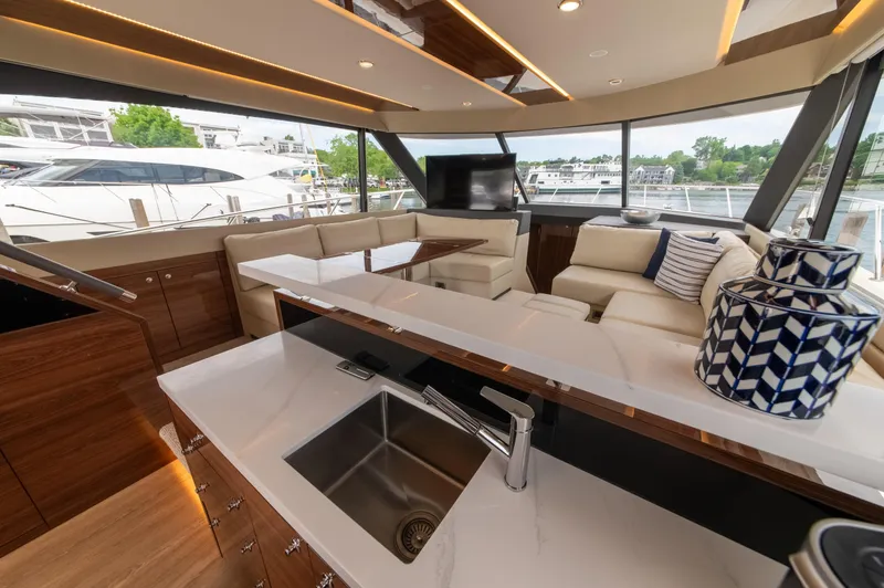 Slide: The Image of Luxurious interior of 2024 Maritimo M55 yacht with modern kitchen and seating area. - 24