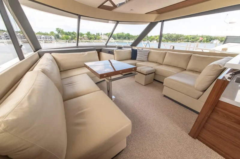 Slide: The Image of Luxurious interior of 2024 Maritimo M55 yacht with beige leather seating and panoramic windows. - 27