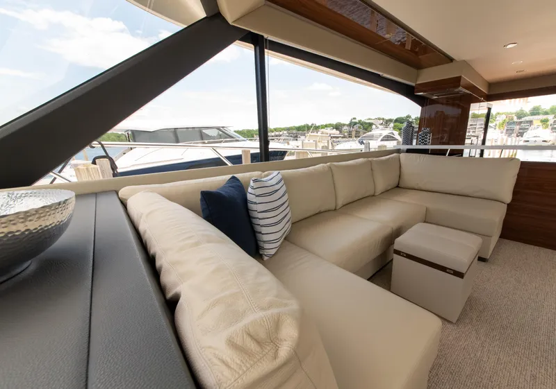 Slide: The Image of Luxurious interior of 2024 Maritimo M55 yacht with cream leather seating and scenic marina view. - 28