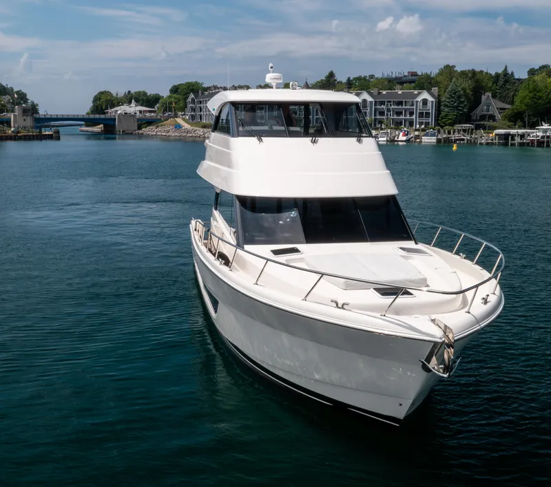 Slide: The Image of 2024 Maritimo M55 yacht cruising in a scenic harbor setting. - 3