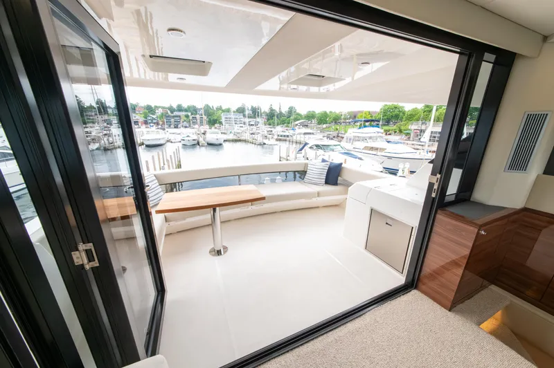 Slide: The Image of Luxurious 2024 Maritimo M55 yacht interior with marina view, featuring sleek design and comfortable seating. - 49