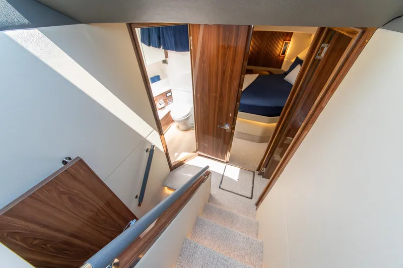Slide: The Image of 2024 Maritimo M55 yacht interior with stairs, bedroom, and bathroom. - 57