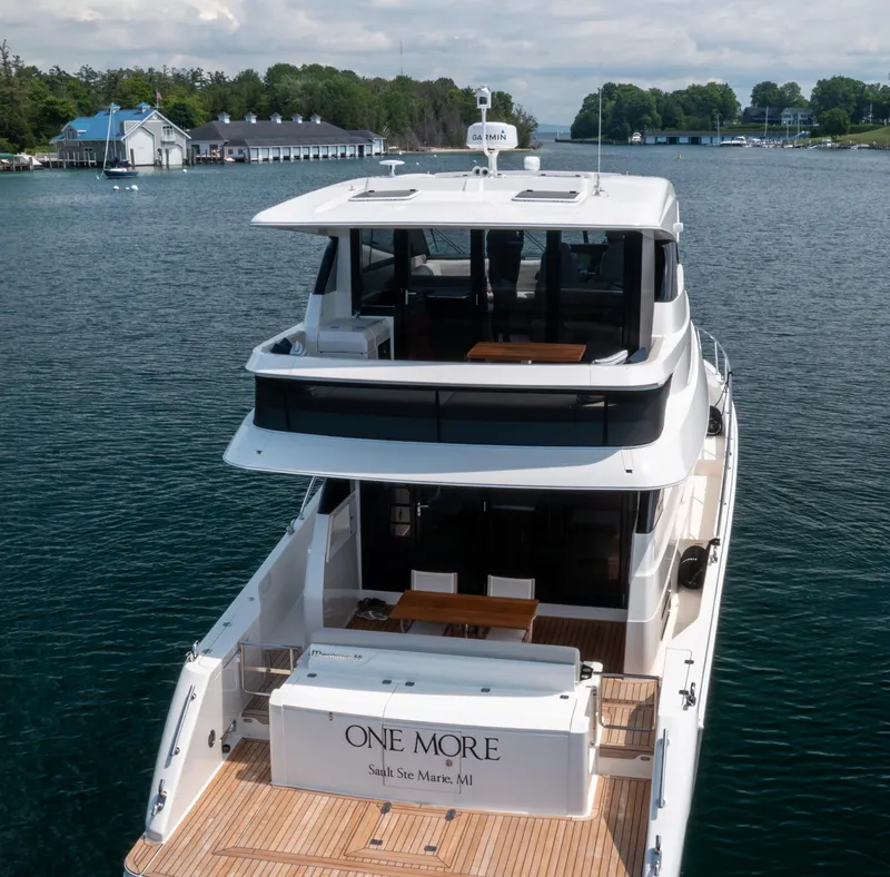 Slide: The Image of 2024 Maritimo M55 yacht on water, rear view, docked near shoreline. - 6