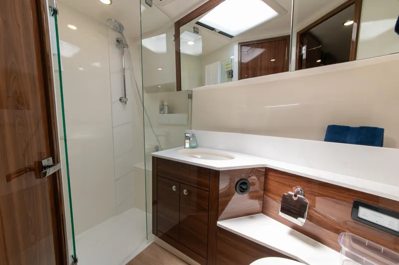 Slide: The Image of Luxurious bathroom in 2024 Maritimo M55 yacht with modern fixtures and elegant wood cabinetry. - 61