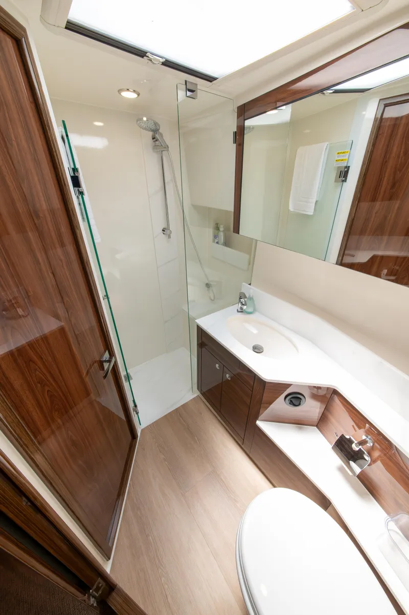 Slide: The Image of Luxurious bathroom in 2024 Maritimo M55 yacht with modern fixtures and wood accents. - 62