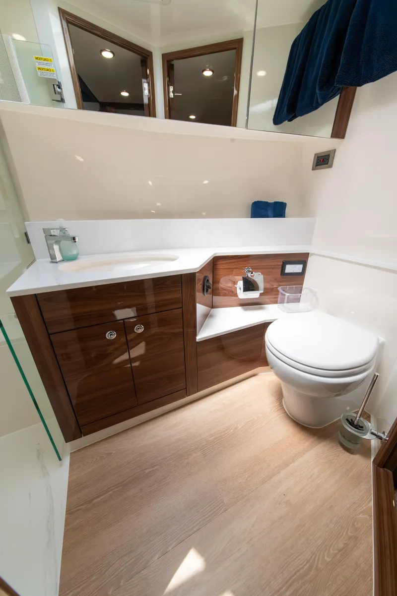 Slide: The Image of Luxurious bathroom in 2024 Maritimo M55 yacht with modern fixtures and wooden cabinetry. - 63