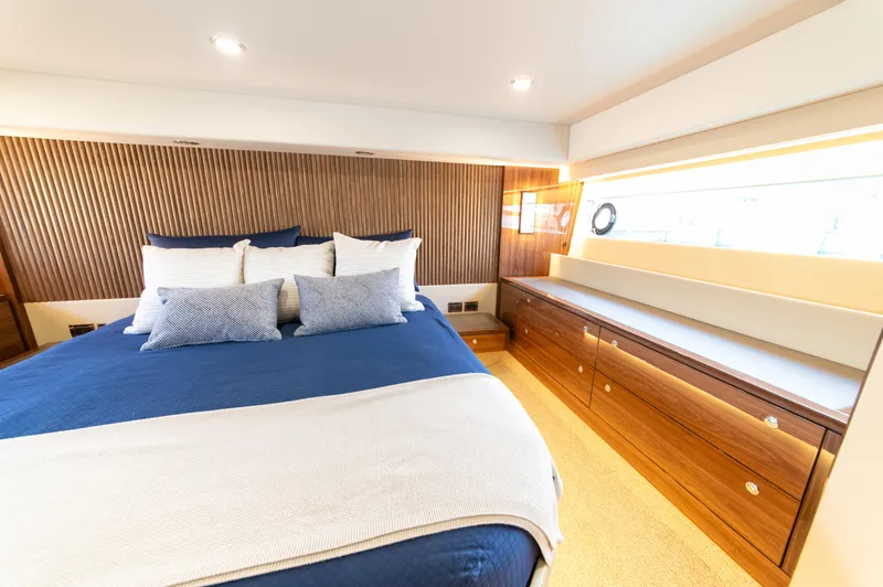 Slide: The Image of Luxurious bedroom interior of 2024 Maritimo M55 yacht with elegant wood paneling. - 67