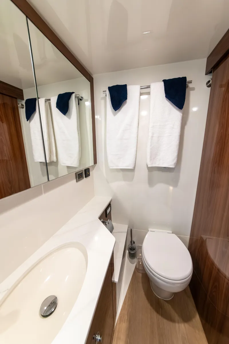 Slide: The Image of Luxurious bathroom in 2024 Maritimo M55 yacht with modern fixtures and elegant wood accents. - 73