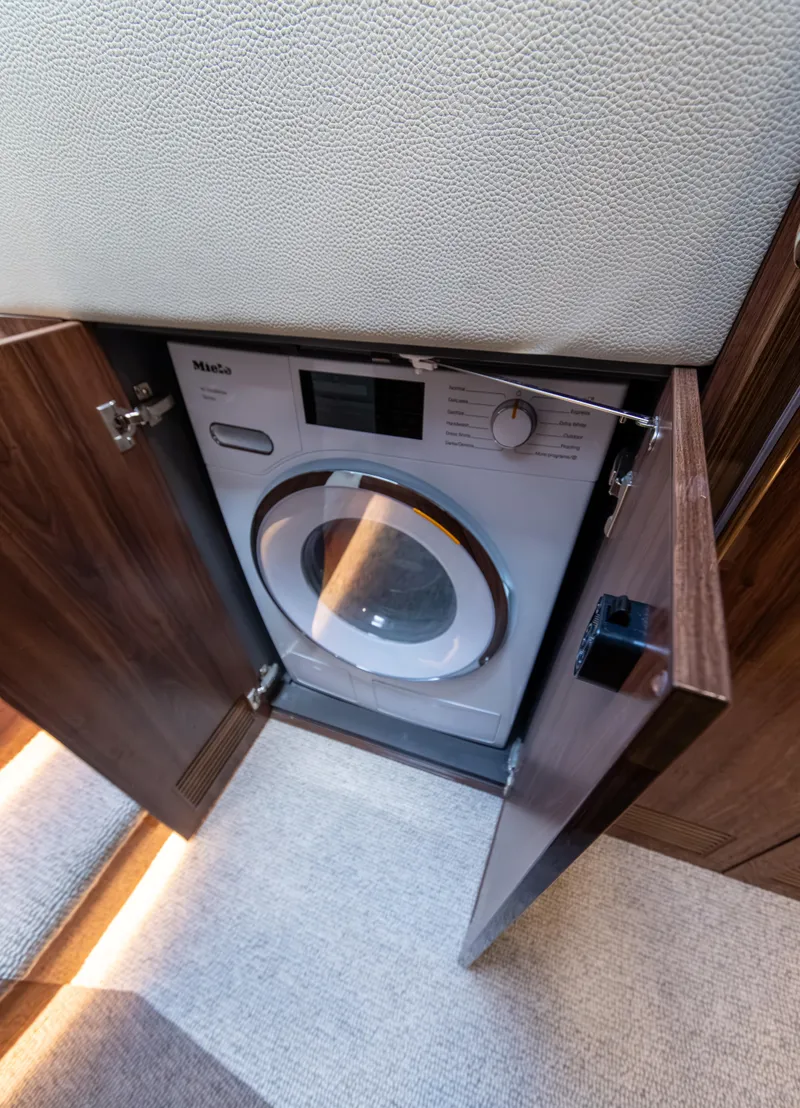 Slide: The Image of 2024 Maritimo M55 yacht interior with built-in Miele washing machine. - 75