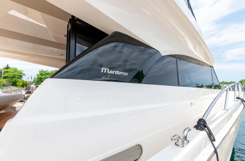 Slide: The Image of 2024 Maritimo M55 yacht, sleek design, docked with clear skies. - 8