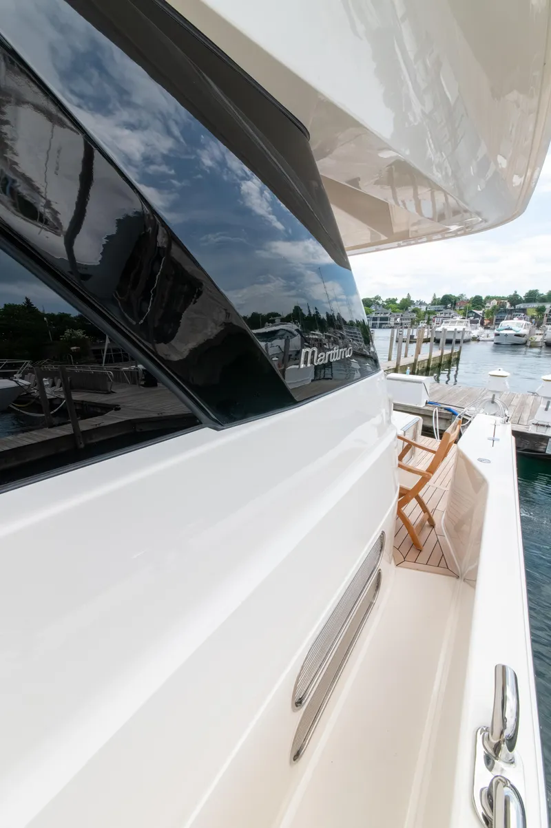 Slide: The Image of 2024 Maritimo M55 yacht docked, showcasing sleek design and luxurious exterior. - 9