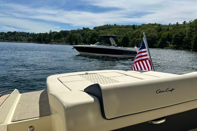 Slide: The Image of 2026 Chris-Craft Sportster 28 on a scenic lake with American flag. - 12
