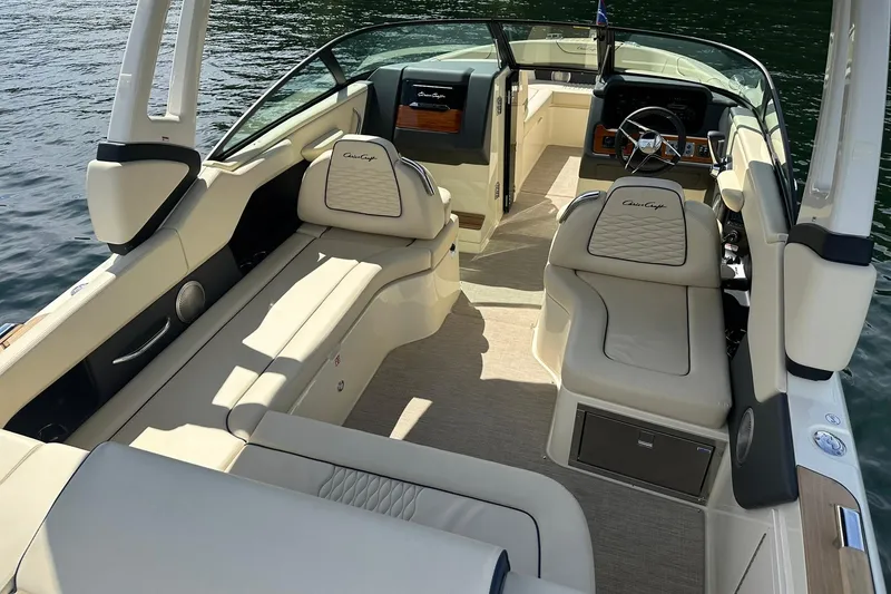 Slide: The Image of 2026 Chris-Craft Sportster 28 boat interior with luxurious seating and elegant design on water. - 14