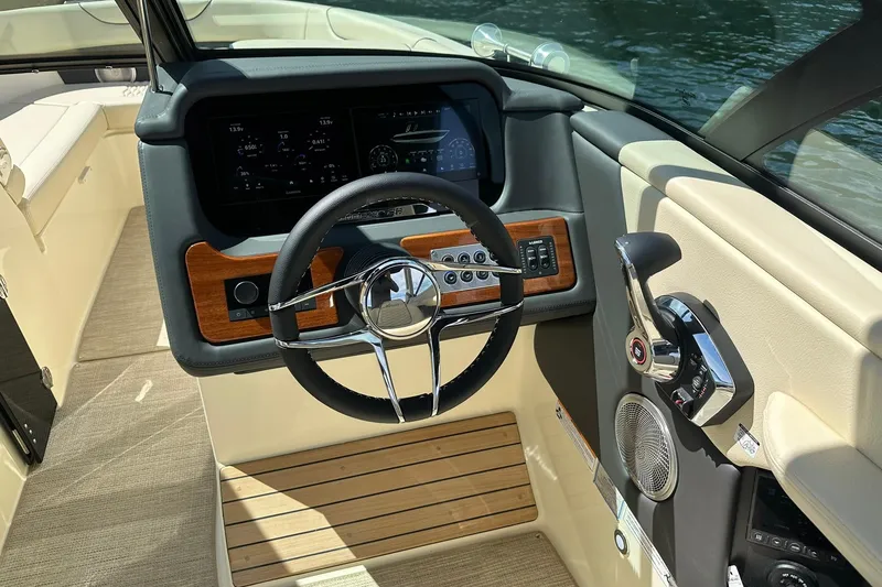 Slide: The Image of 2026 Chris-Craft Sportster 28 dashboard with steering wheel and control panel. - 17